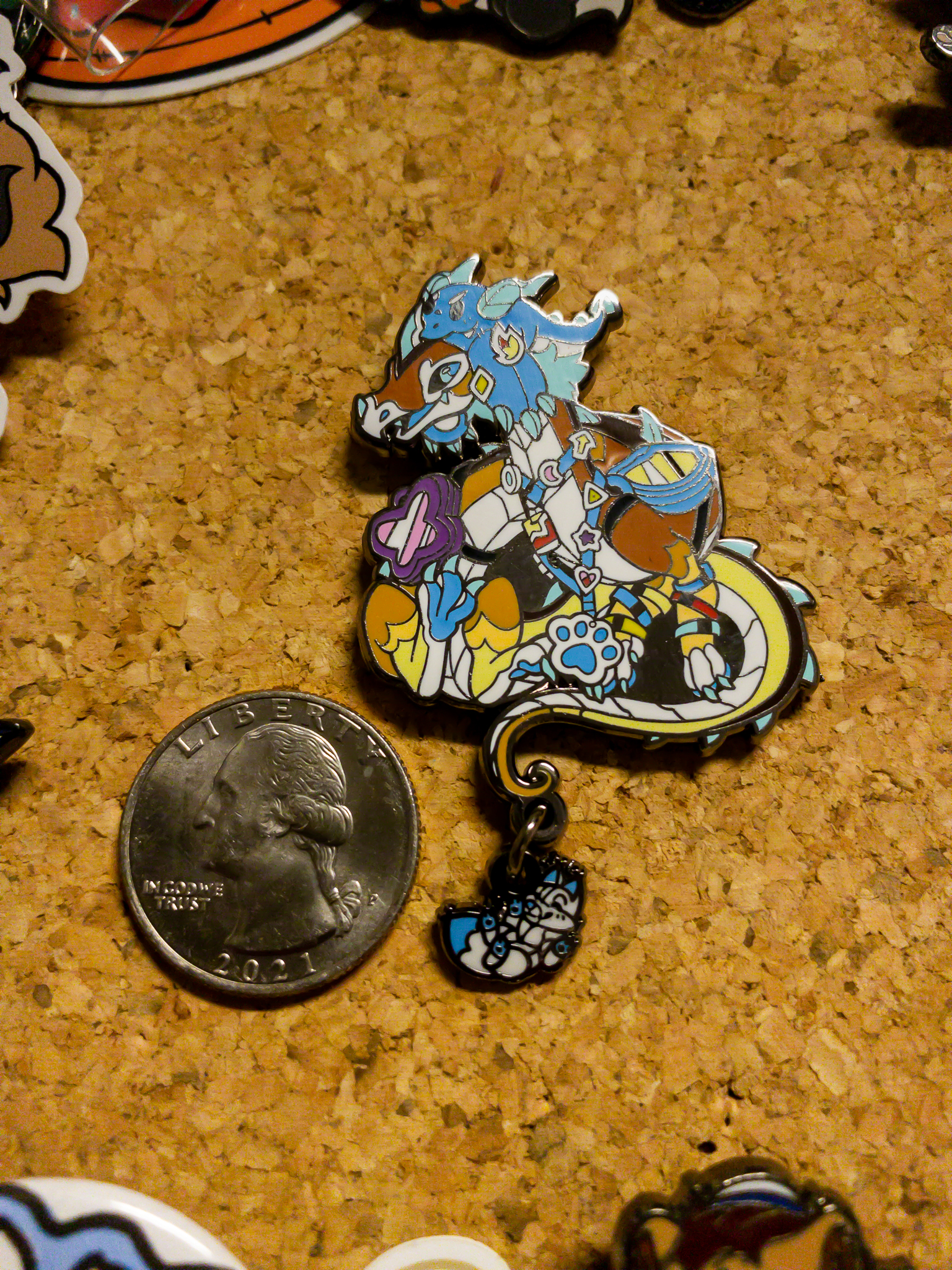 The pin's size, compared to a quarter (1 inch/25 mm)